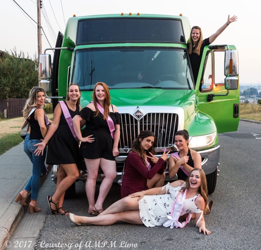Stagette celebration with 6 ladies in front and one lady standing in the door of the green Godzilla Party Bus
