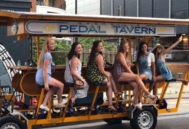 6 ladies on the Pedal Tavern smiling for photo